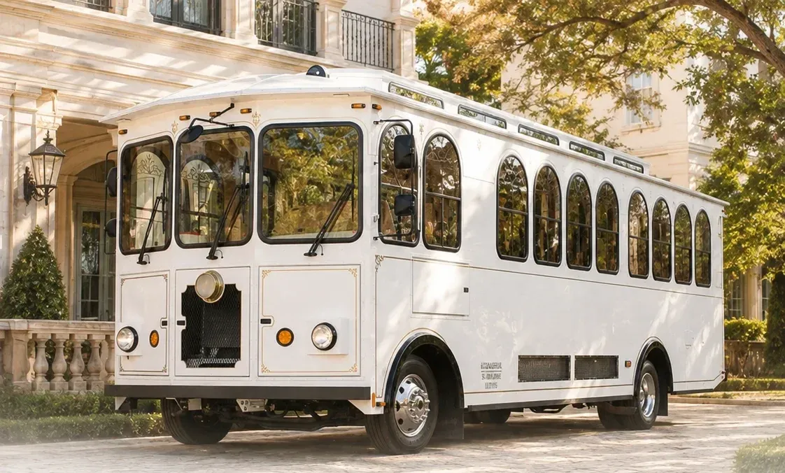 ChiTown Trolley's classic white trolley, parked at the entrance of a wedding venue